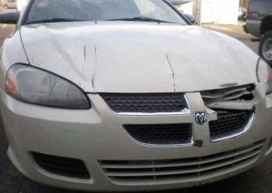 a wrecked Dodge Avenger before Murphy Bros. Auto Body
